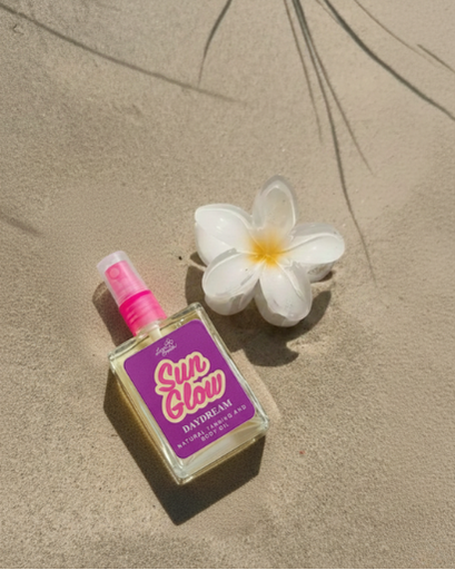 Sun Glow Daydream product on sand with a flower