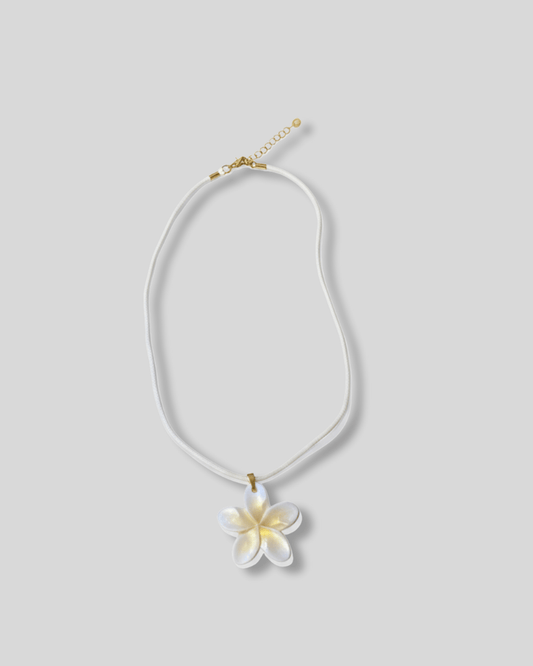 Necklace with a white flower pendant 