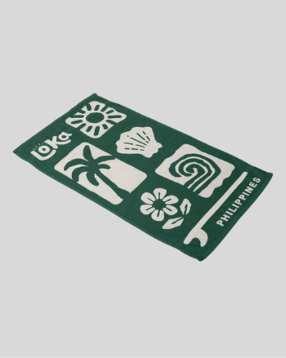Green towel with white patterns and text 