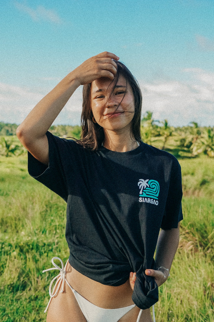 Female model wearing black tee from on cloud 9 collection