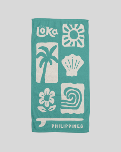 Teal towel with white graphics and 'Loka' branding 